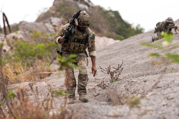 Special Forces Soldier Standing in Smoke During Tactical Operation – Full Combat Gear with Rifle...