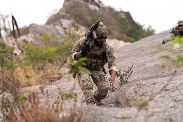 Special Forces Soldier Standing in Smoke During Tactical Operation – Full Combat Gear with Rifle...