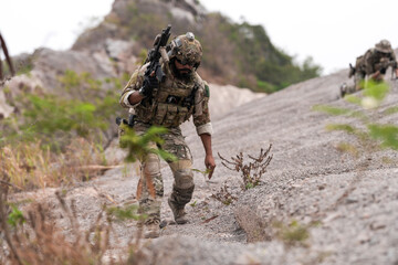 Special Forces Soldier Standing in Smoke During Tactical Operation – Full Combat Gear with Rifle...