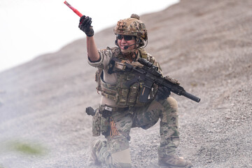 Special Forces Team During Military Operation on Rocky Slope – Soldier Holding Red Flare and...