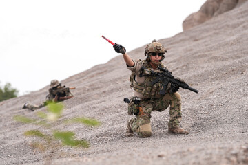 Special Forces Team During Military Operation on Rocky Slope – Soldier Holding Red Flare and...