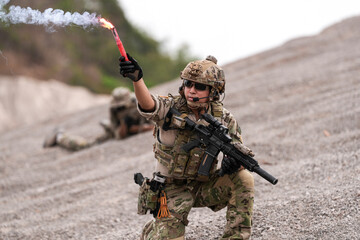 Special Forces Team During Military Operation on Rocky Slope – Soldier Holding Red Flare and...