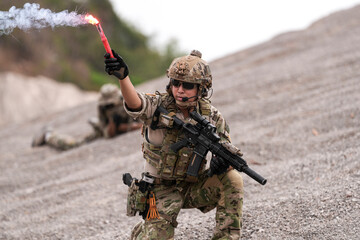 Special Forces Team During Military Operation on Rocky Slope – Soldier Holding Red Flare and...