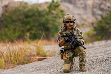Special forces soldier uses a radio during a tactical operation while red flare smoke spreads...