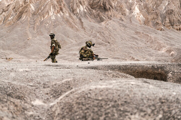Three Soldiers in Combat Gear Holding Tactical Positions on Rocky Terrain – Realistic Military...