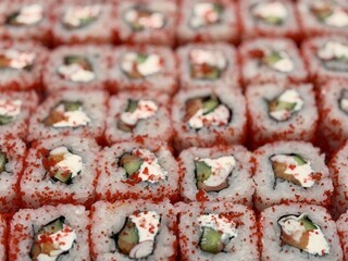 Indulge in these utterly Delicious Sushi Rolls beautifully Garnished with Bright Red Tobiko. Vibrant array of sushi rolls topped with red tobiko, perfect for food enthusiasts and cuisine photography
