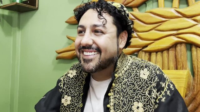 Horizontal 4k video of a Lebanese man in traditional clothing drinking Arabic coffee in his cup at a traditional Lebanese restaurant.	
