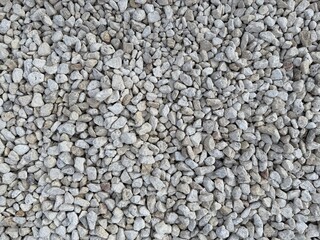 Close-Up of Light Gray Crushed Gravel Stones for Landscaping and Construction Background