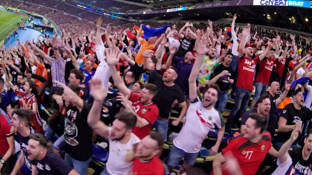 Wide-angle video captures a vibrant soccer stadium at night, showcasing a dynamic match with a packed audience and bright floodlights.