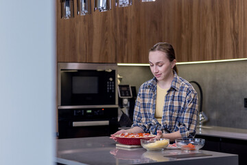 Smiling Woman in Kitchen Showing Freshly Baked Quiche Lorraine