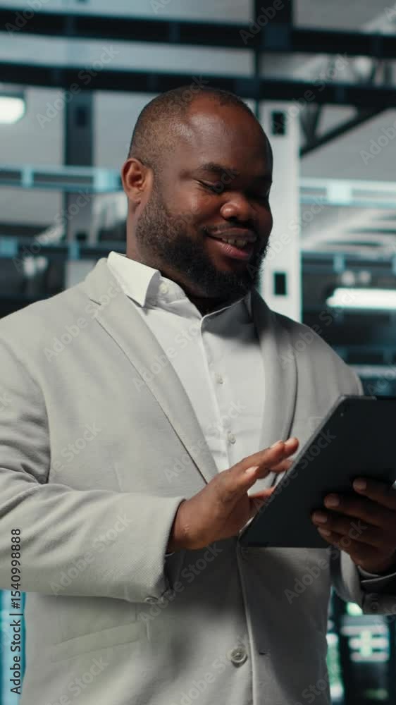 Poster vertical video server room worker troubleshooting server connectivity issues using software on table