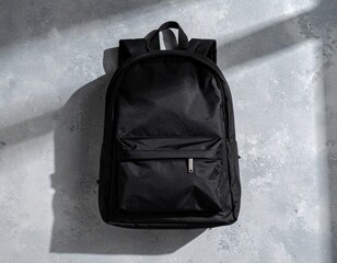 Matte Black Backpack on Concrete Background – Top View