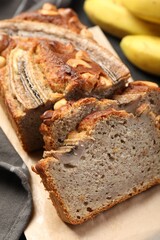 Cut banana bread with nuts on table, closeup