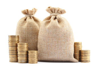 Bags and stacked coins isolated on white