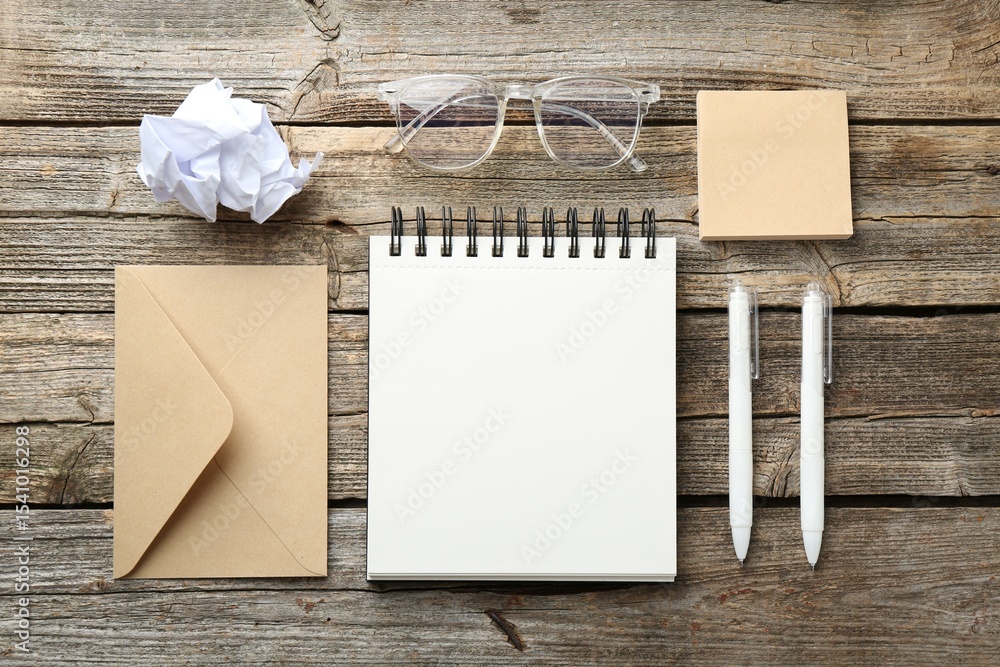 Aufkleber flat lay composition with open blank notebook on wooden table