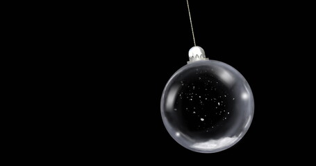 Hanging glass bauble by thin string in studio, with silver cap and white speckles, copy space
