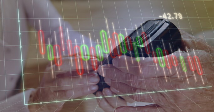 Two seniors studying smartphone with candlestick-chart overlay at wooden table at home