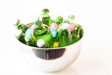 Various fruit flavored and plain mineral waters with ice cubes in stainless steel bowls