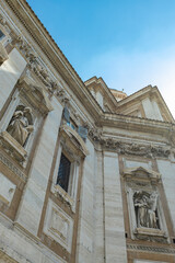 View of the side facade of the Basilica of Santa Maria Maggiore from Via Liberiana, in the city of Rome, on a sunny day.