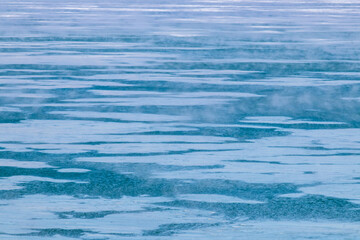 Frozen blue lake with floating ice