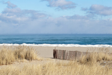 Sandy lake beach in the winter with steamy horizon
