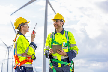 Engineer team man and woman working together with tablet,  survey plan construction wind turbine...
