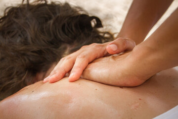 Neck massage therapy session with hands applying pressure on cervical area

