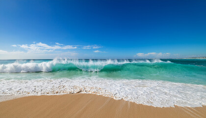 vibrant turquoise waves crash onto the sandy beach under an azure blue sky creating an invigorating and fresh coastal scene perfect for ocean admiration