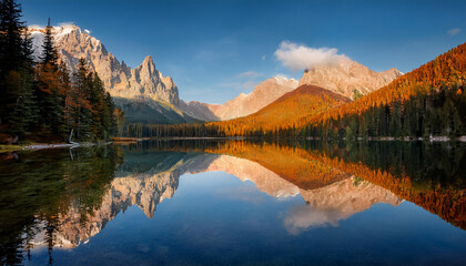 Fototapeta premium majestic mountains reflect in the still waters of the lake