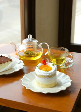 Beautiful mini cake on white plate. Decorated cake with slices of oranges, peach and strawberry on top. Dessert for party, celebration, festive, and Eid mubarak