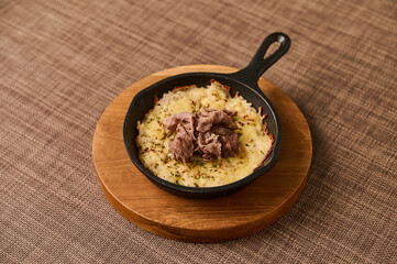 Cheesy Beef Skillet with Melted Cheese on Wooden Board