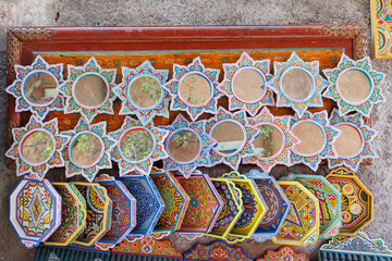 Scenic street view of market stalls and traditional Moroccan plates in the Old Town Medina area of Marrakech, west Morocco