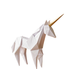 Modern, geometric unicorn sculpture with white body and golden horn, crafted with sharp, angular facets that give it contemporary and artistic appearance