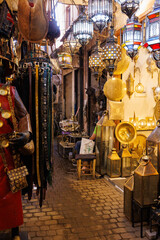 Scenic street view of market stalls and traditional Moroccan products in the Old Town Medina area of Marrakech, west Morocco