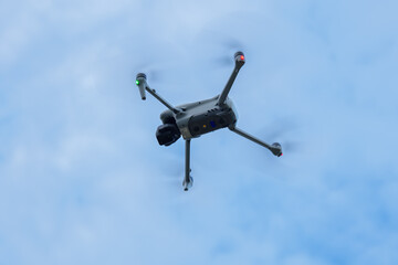 Engineer operating drone at construction site for industrial inspection and surveillance, ensuring safety, power infrastructure development, and environmental monitoring with advanced remote control t