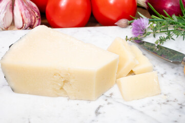 Pieces of matured pecorino romano italian cheese made from sheep milk in Lazio, Sardinia or Tuscany