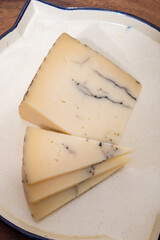 Tasty Spanish hard cheese, cow and sheep curado, manchego, goat cheese with added black truffle...