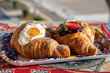 Italian breakfast, fresh baked butter croissants filled with ricotta cheese and jam, served outdoor...