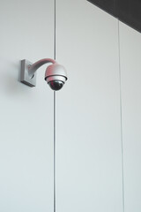 Security camera mounted on a white wall indoors