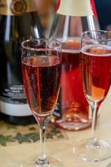 Pouring and tasting of rose or pink cuvee sparkling wine brut, grand reserve, champagne in Ay-Champagne wine making village in Vallee de la Marne, , Champagne region, France