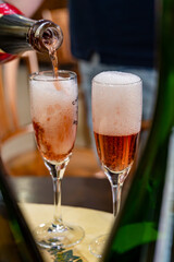 Pouring and tasting of rose or pink cuvee sparkling wine brut, grand reserve, champagne in Ay-Champagne wine making village in Vallee de la Marne, , Champagne region, France