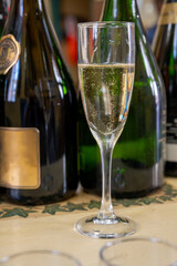 Pouring and tasting of dry sparkling wine brut, grand reserve, champagne in Ay-Champagne wine making village in Vallee de la Marne, , Champagne region, France