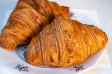 Fresh baked two buttered croissants served in restaurant for continental or French breakfast on...