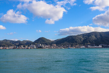 Panoramic View of Kitakyushu Skyline with Mountains and Ocean under Blue Sky, Japan