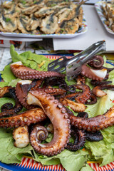Catch of the day, fresh tasty seafood, grilled octopus sicilian style on fish marken in Palermo, Sicily, Italy, streed food on market