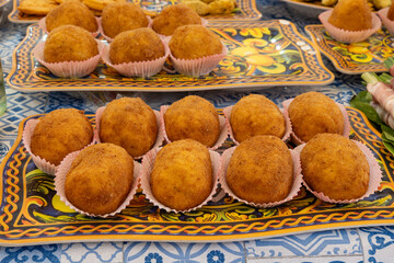 Arancini Sicilian, deep-fried rice balls made with risotto, filled with ingredients mozzarella,...