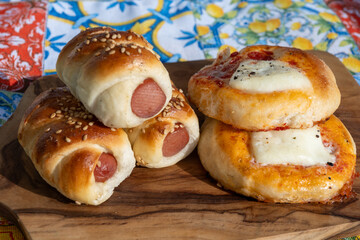 Fresh baked bread, pizza, focaccia or pizzetta with tomatoes, vegetables, sausage and cheese, street food in Palermo, Sicily, Italy, served outdoor for lunch