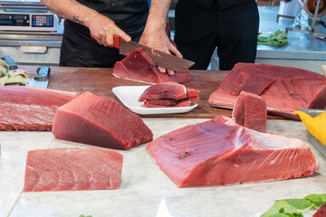 Assortment of fresh ocean daily catch of large tuna, spada, sharks fish on fish market in Palermo,...