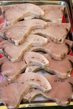 Assortment of fresh ocean daily catch of large tuna, spada, sharks fish on fish market in Palermo, Sicily, Italy, spigole fish