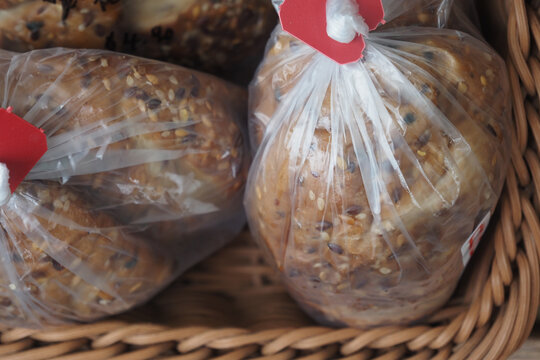 Bakery display of assorted freshly packed breads in bags